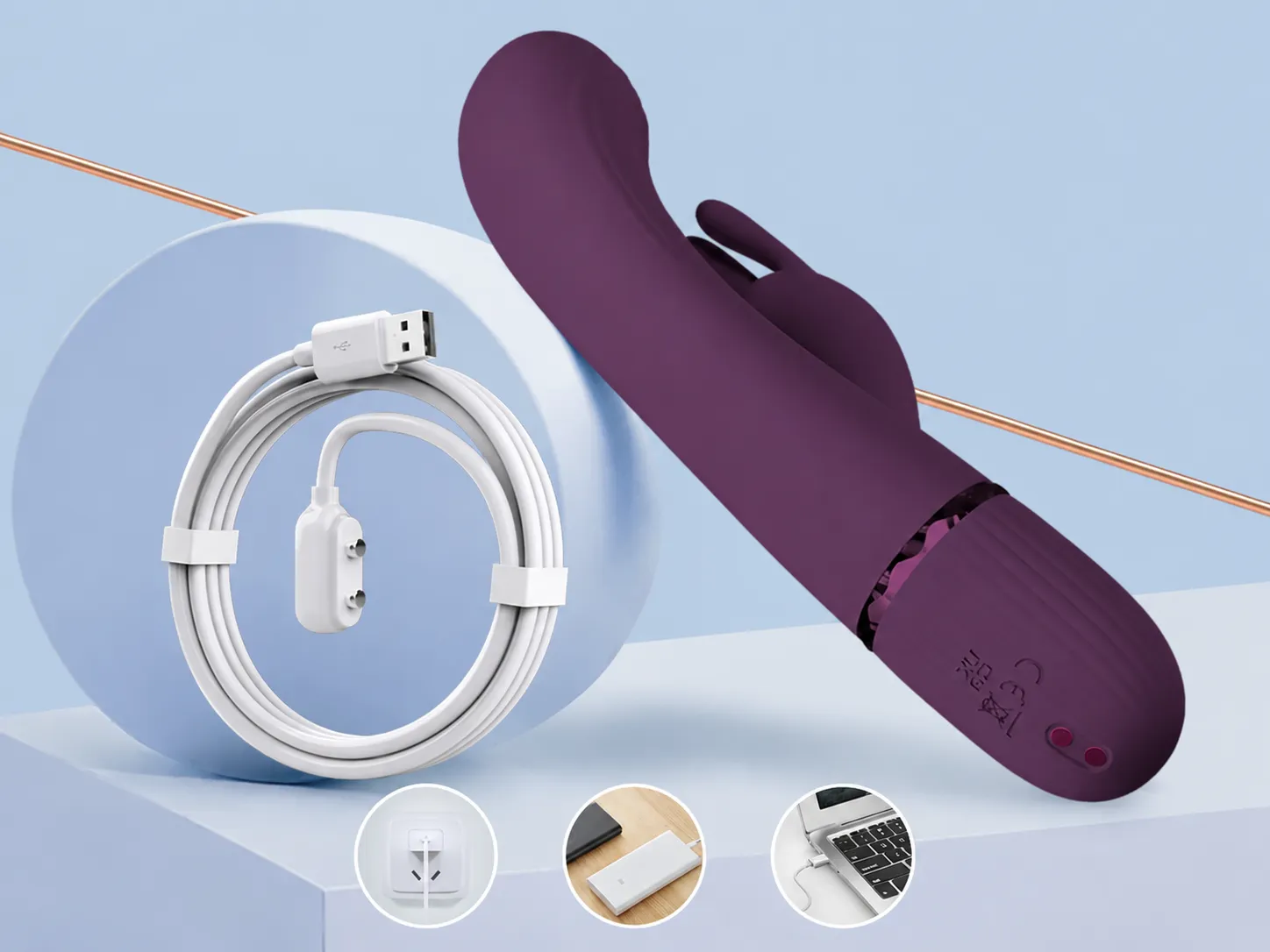 Scocco G-spot rabbit vibrator in purple with its magnetic USB charging cable coiled beside it