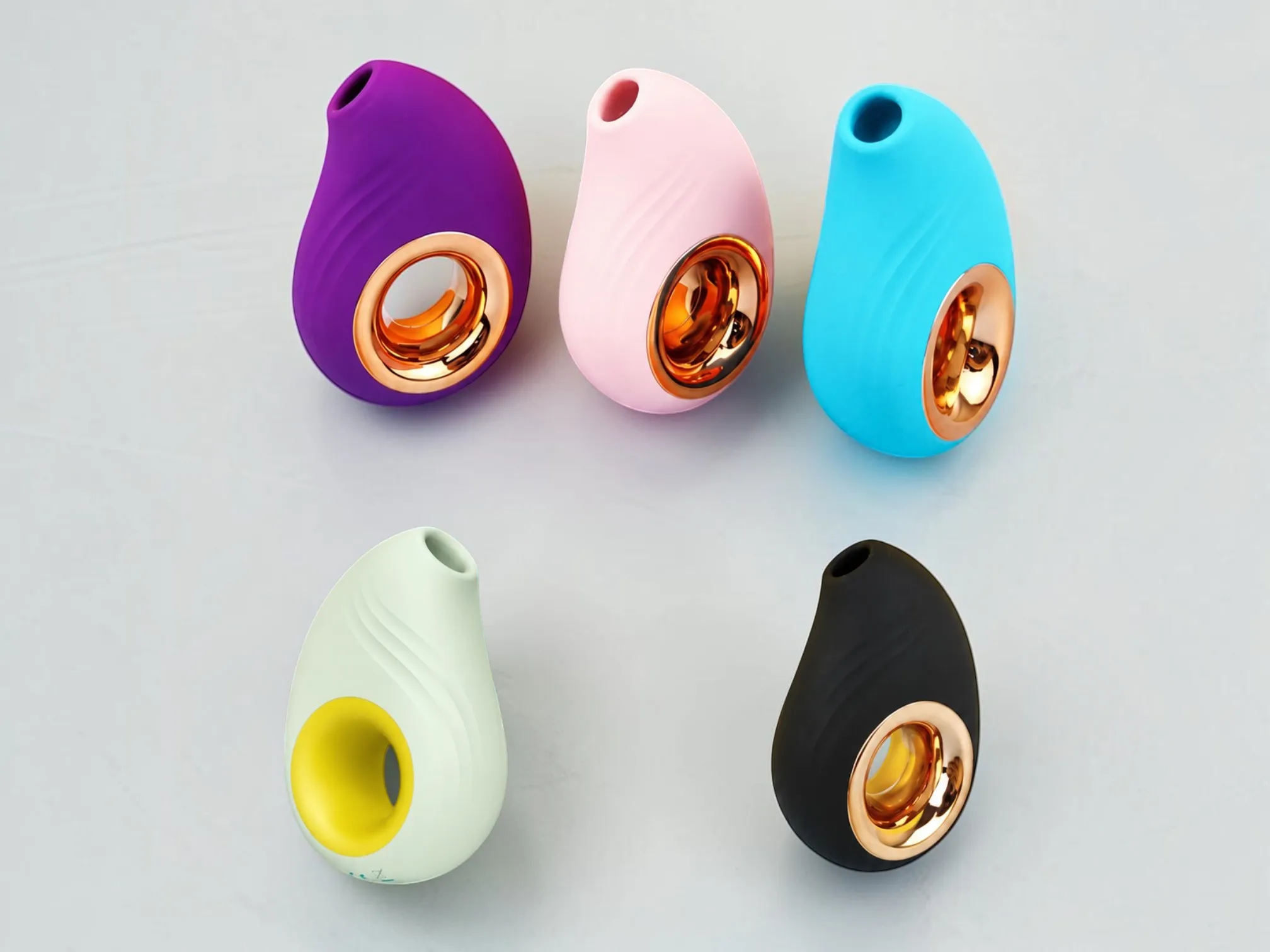 SonaWave Pebble clitoral suction toy shown in purple, blush pink, blue, soft sage, and black
