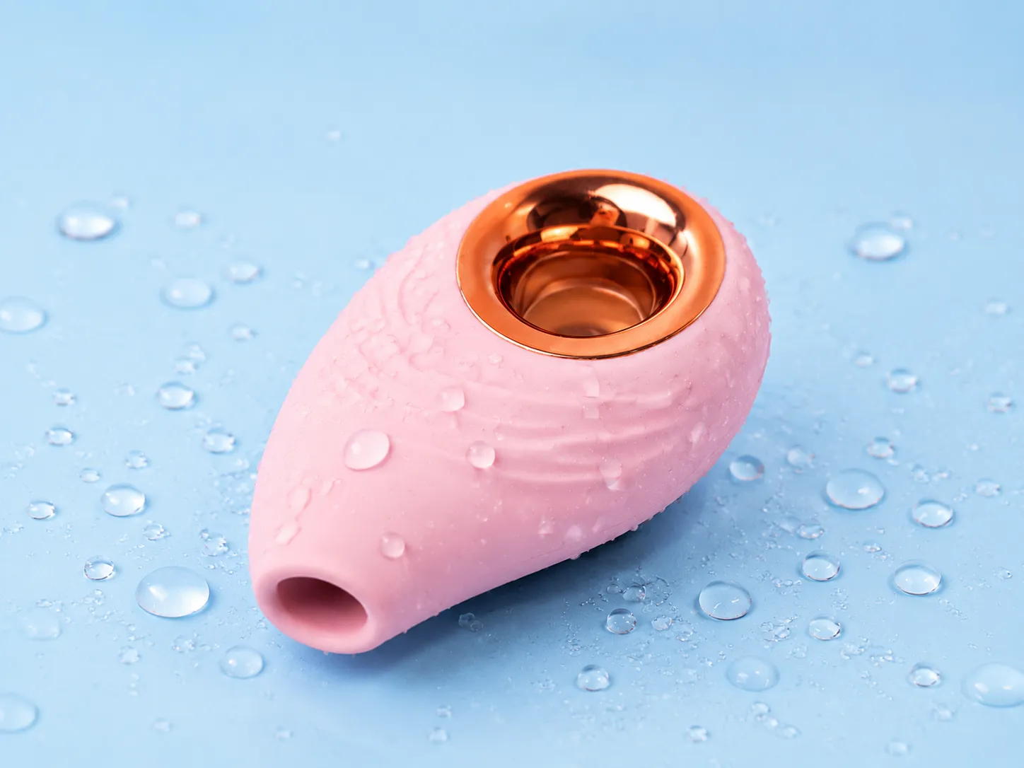 SonaWave Pebble clitoral suction toy being rinsed under running water, IPX6 water-resistant