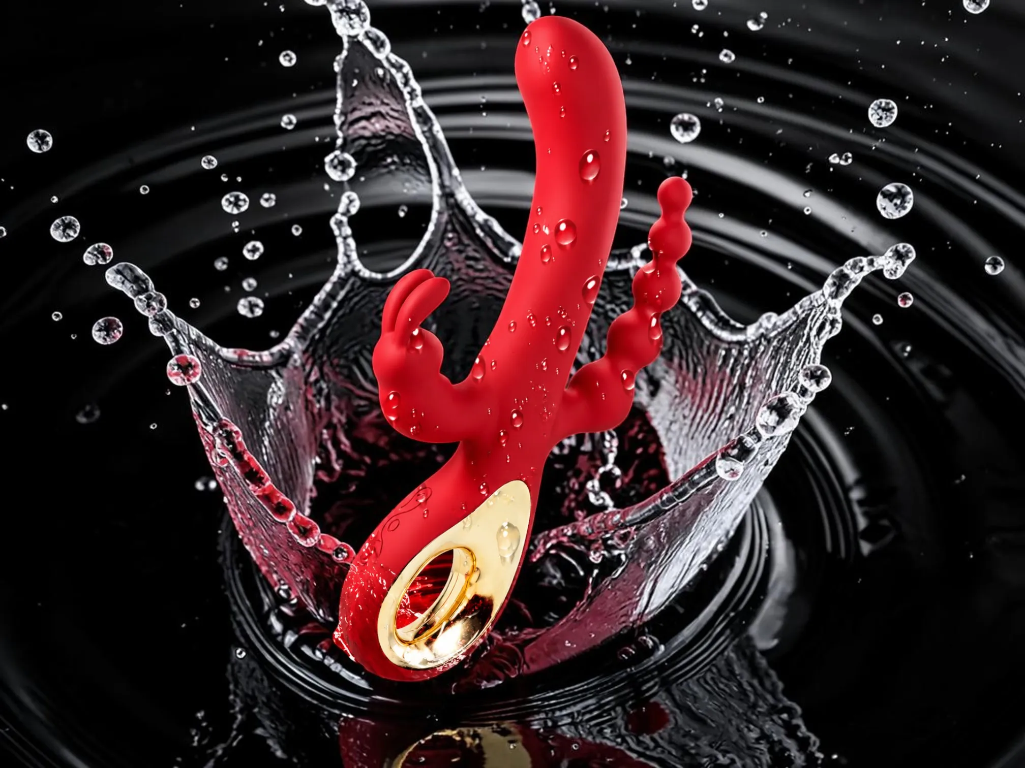 Sensitive triple stimulation rabbit vibrator in red splashing in water, showing its rinse-clean body-safe silicone