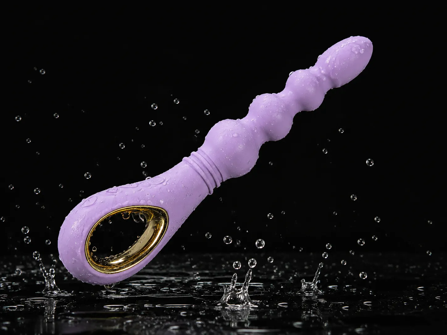 CoreSeal Cascade beaded anal vibrator in soft lavender with water splashing around it on a black background