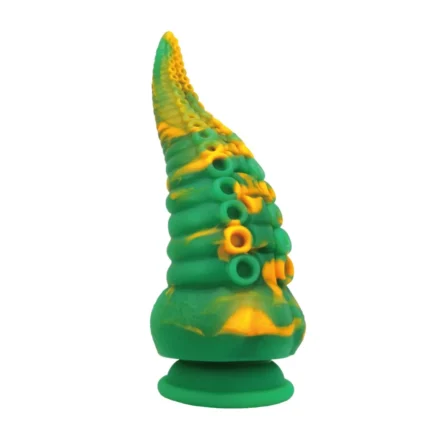 Green and yellow tentacle monster dildo with suction cup base displayed next to its Power Monsters retail box