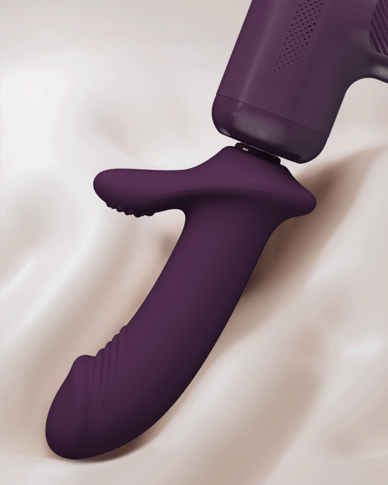 Soft silicone attachment head seated on the handle of a deep plum thrusting massager