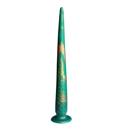 Front view of a long tapered tail dildo with scaled texture standing upright on a suction cup base