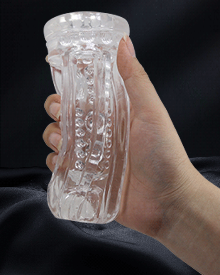 Hand squeezing a soft clear TPR masturbator sleeve to show how far it gives