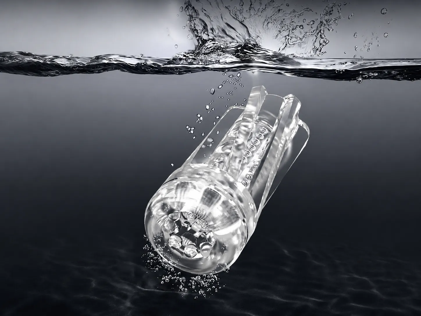 Clear TPR masturbator sleeve submerged in water, shown separately from the battery base